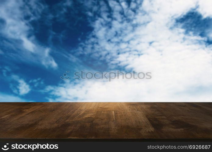 Image of wooden table in front of abstract blurred background of outdoor garden lights. can be used for display or montage your products.Mock up for display of product.