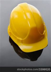 Image of yellow construction helmet on a black background