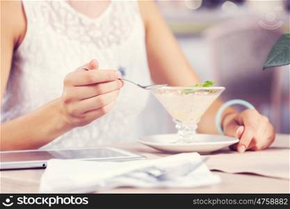 Image of young and pretty woman having dessert in cafe