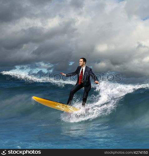 Image of young business person surfing on the waves of the ocean