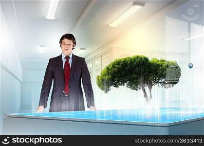 Image of young businessman against high-tech picture of environment concept
