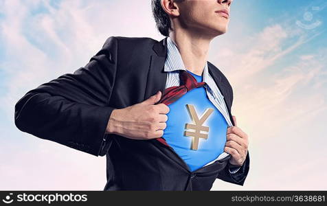 Image of young businessman in superhero suit with yen sign on chest