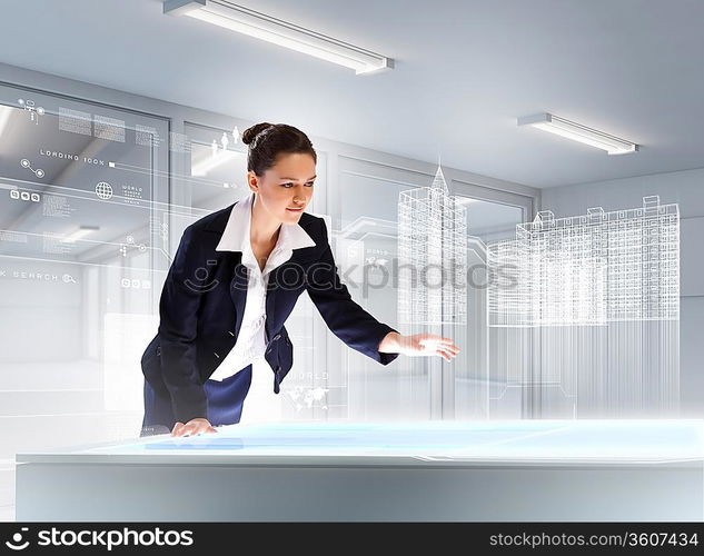 Image of young businesswoman clicking icon on high-tech picture