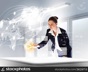 Image of young businesswoman clicking icon on high-tech picture