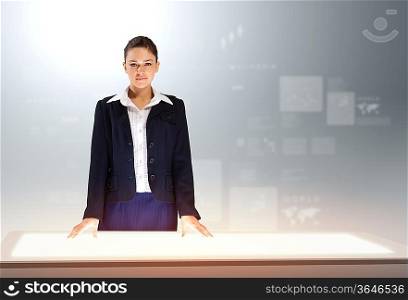 Image of young businesswoman standing against high-tech picture background