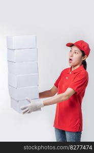 Image of  young delivery man in red cap blank t-shirt uniform standing with empty white cardboard box isolated on light gray background studio