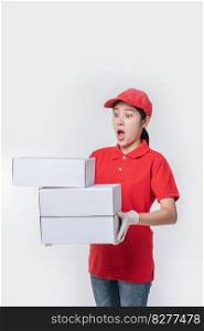Image of  young delivery man in red cap blank t-shirt uniform standing with empty white cardboard box isolated on light gray background studio