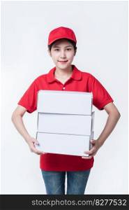 Image of  young delivery man in red cap blank t-shirt uniform standing with empty white cardboard box isolated on light gray background studio
