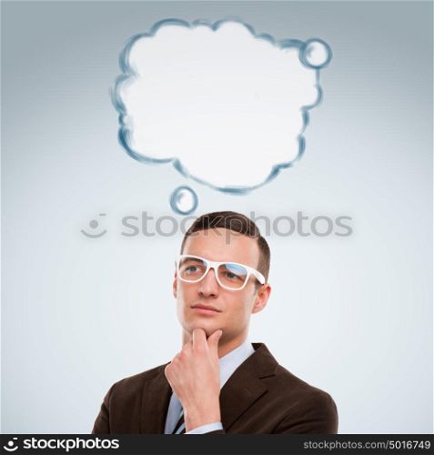 Image of young man thinking of his plans. Lots of copyspace inside graphic cloud for your text