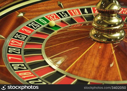 image with a casino roulette wheel with the ball on number 0