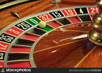 image with a casino roulette wheel with the ball on number 0