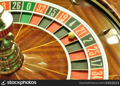 image with a casino roulette wheel with the ball on number 21