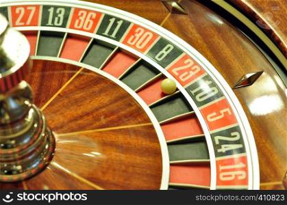 image with a casino roulette wheel with the ball on number 23