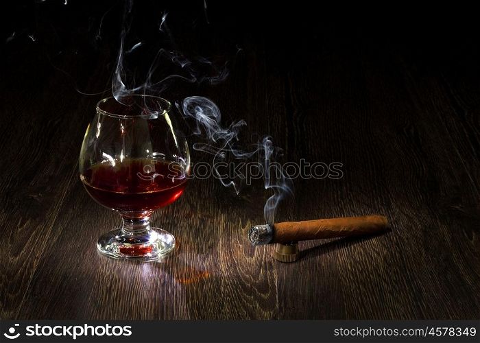 Image with a glass of cognac and cigar
