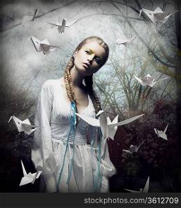 Imagination. Romantic Blonde with Hovering Origami Birds in Spooky Forest. Magic