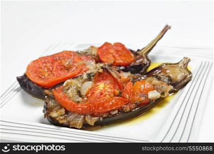 Imam balidi or Imam melitzanes, a delicious Greek or Turkish vegetarian dish of eggplant (aubergine) stuffed with onion, garlic, parsley and tomato and baked in virgin olive oil.