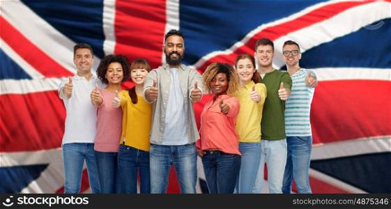 immigration, diversity, race, ethnicity and people concept - international group of happy smiling men and women showing thumbs up over english flag background