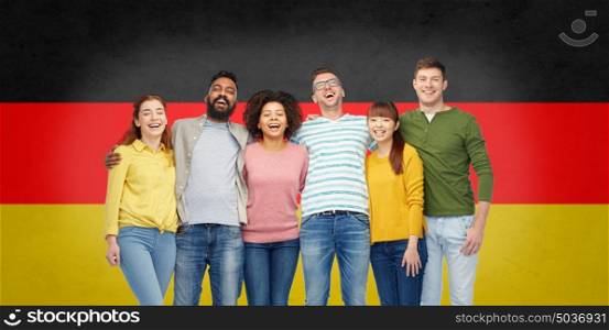 immigration, diversity, race, ethnicity and people concept - international group of happy smiling men and women showing thumbs up over german flag background. international group of happy smiling people