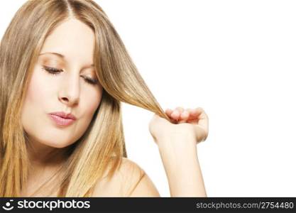 impishly blonde woman playing with her hairs. impishly blonde woman playing with her hairs on white background