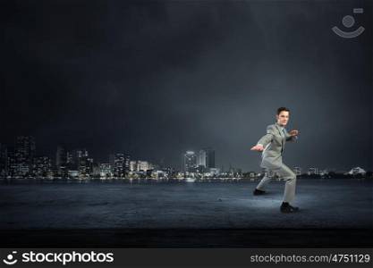 Impossible mission. Cheerful young businessman demonstrating self defence element