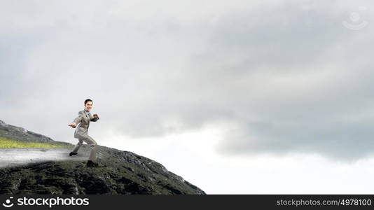 Impossible mission. Cheerful young businessman demonstrating self defence element