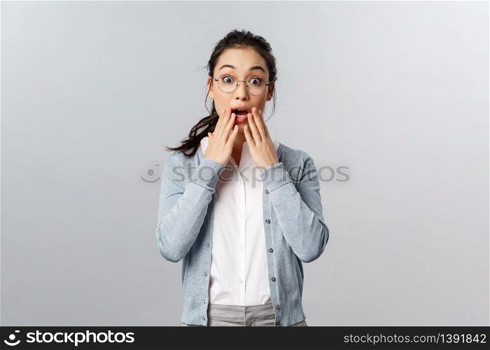 Impressed, excited attractive asian woman react to wonderful amazing news, hold hands near opened mouth, gossip with coworker, listen to incredible story, awesome prices on sale day.. Impressed, excited attractive asian woman react to wonderful amazing news, hold hands near opened mouth, gossip with coworker, listen to incredible story, awesome prices on sale day