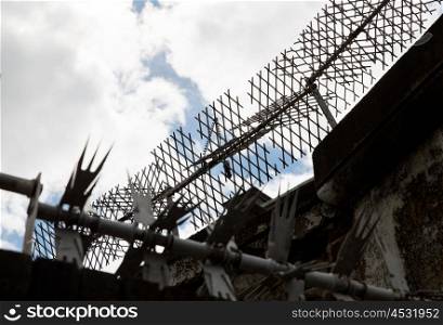imprisonment concept - close up of fence with barbed wire and mesh in prison. close up of fence with barbed wire and mesh