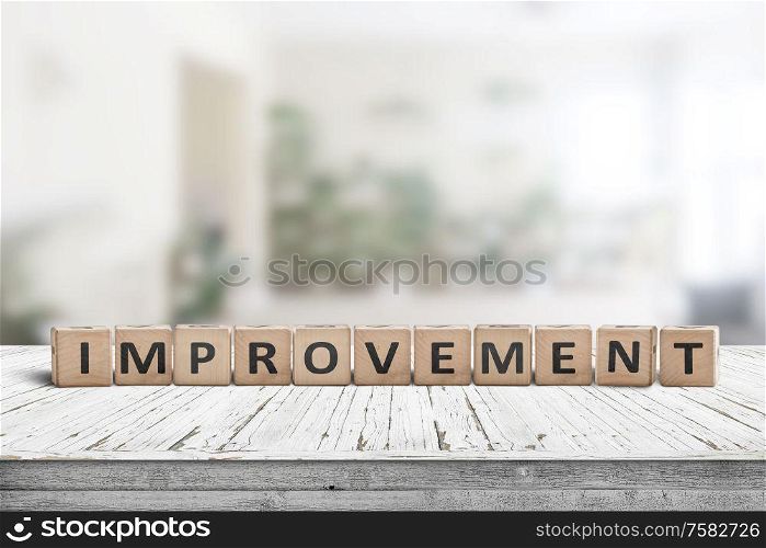 Improvement sign on a wooden office desk in a bright room with green colors
