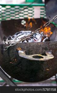 improvised brazier with burning wood in it.Selective focus. unusual grill