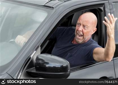 impulsive and energetic mature man shouting out of the window