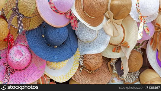 in a old market lots of colorated hats like background clothes