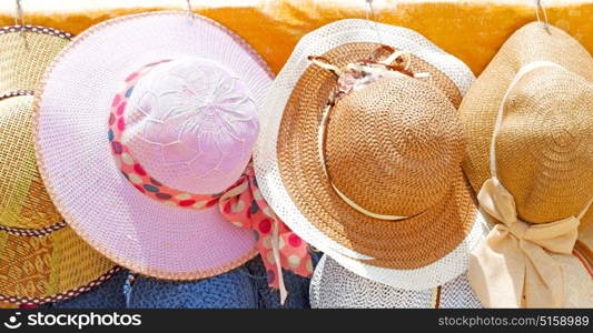 in a old market lots of colorated hats like background clothes