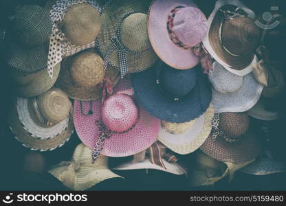 in a old market lots of colorated hats like background clothes