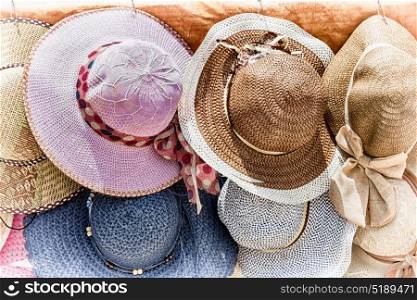 in a old market lots of colorated hats like background clothes