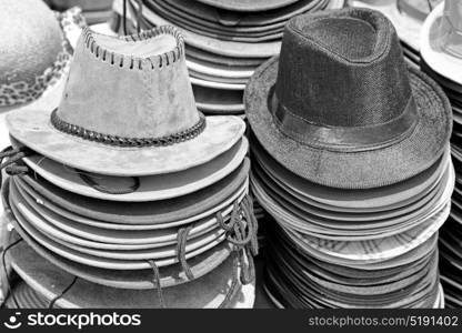 in a old market lots of colorated hats like background clothes