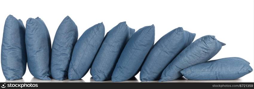 in a row blue denim pillows isolated on white