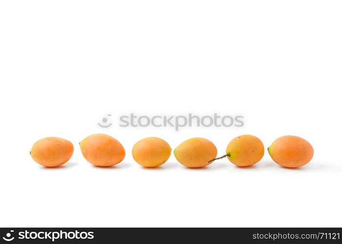 in a row of yellow marian plum fruit