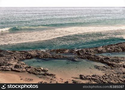 in australia fraser island the beach near the rocks in the wave of ocean