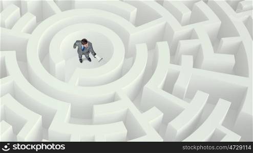 In center of problem Mixed media. Businessman with megaphone standing in center of maze