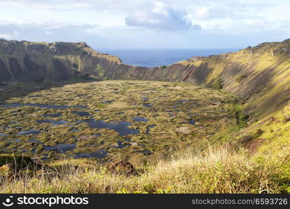 in chile rapa nui the antique and mysteriuos volcano and lake near ocean nature and park
