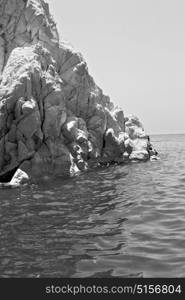 in europe greece santorini island hill and rocks on the summertime beach