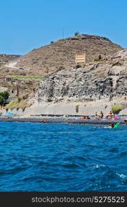 in europe greece santorini island hill and rocks on the summertime beach