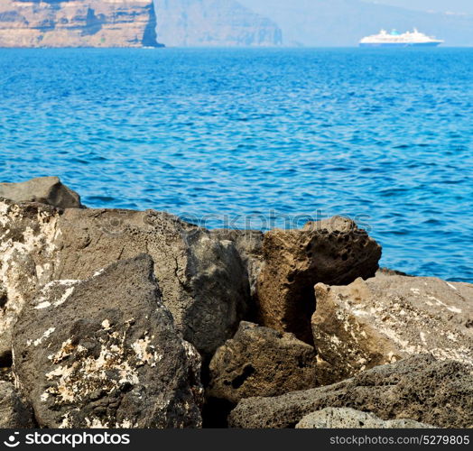 in europe greece santorini island hill and rocks on the summertime beach