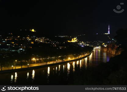 in georgia tbilisi the view of the city   near the river and old architecture in the night blur and noise
