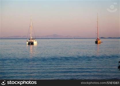 in greece near the coastline boat and yacht and sunrise light
