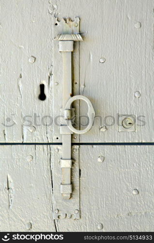 in italy patch lombardy cross castellanza blur abstract rusty brass brown knocker a door curch closed wood