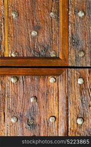 in italy patch lombardy cross castellanza blur abstract rusty brass brown knocker a door curch closed wood