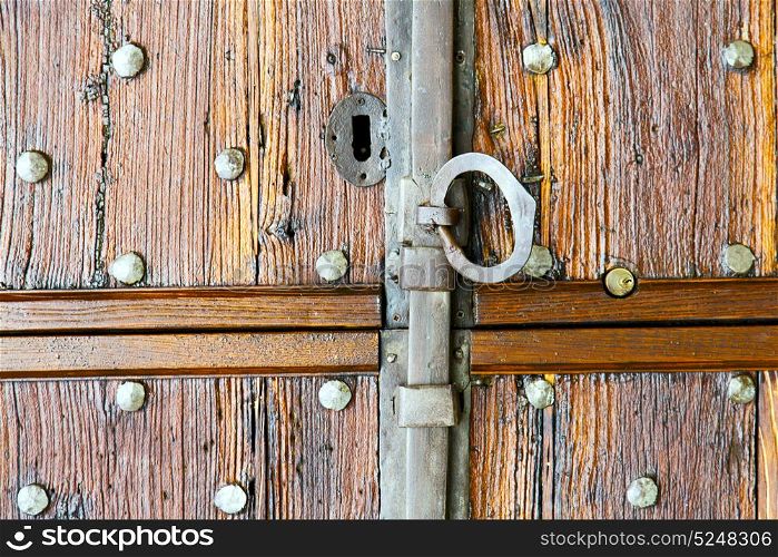 in italy patch lombardy cross milan blur abstract rusty brass brown knocker a door curch closed wood