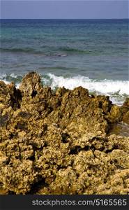 in lanzarote isle foam rock spain landscape stone sky cloud beach water