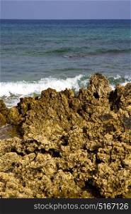 in lanzarote isle foam rock spain landscape stone sky cloud beach water